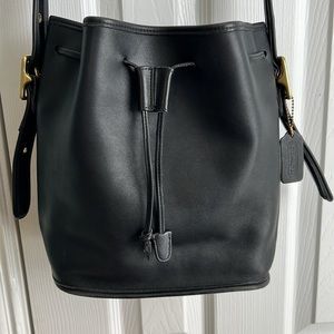 Coach soft black leather bucket bag with drawstring closure.